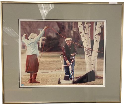 Lot #29.2 Photo by Record Photographer - Two elderly people co-cutting the grass