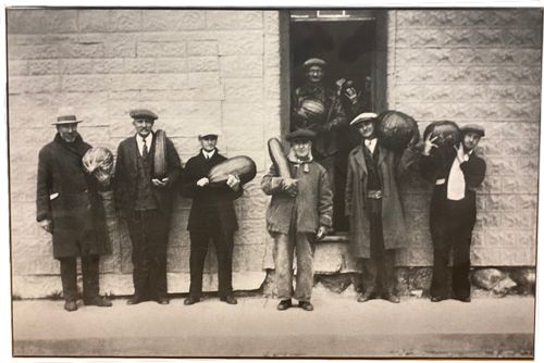 Lot #40.5 Men holding produce Image mounted on board Floating from wall backing