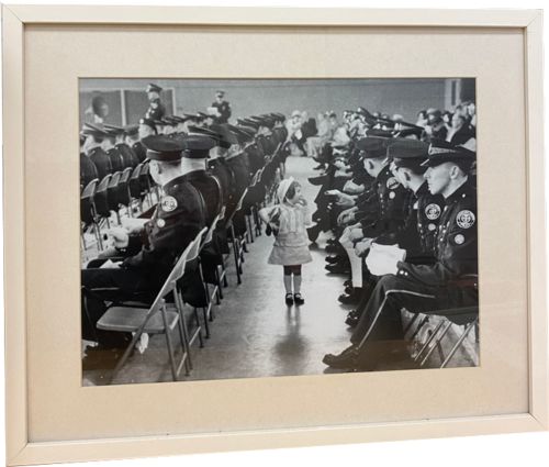 Lot # 43.5 Photograph of little girl looking for her father at a police graduation ceremony - Feature 1967